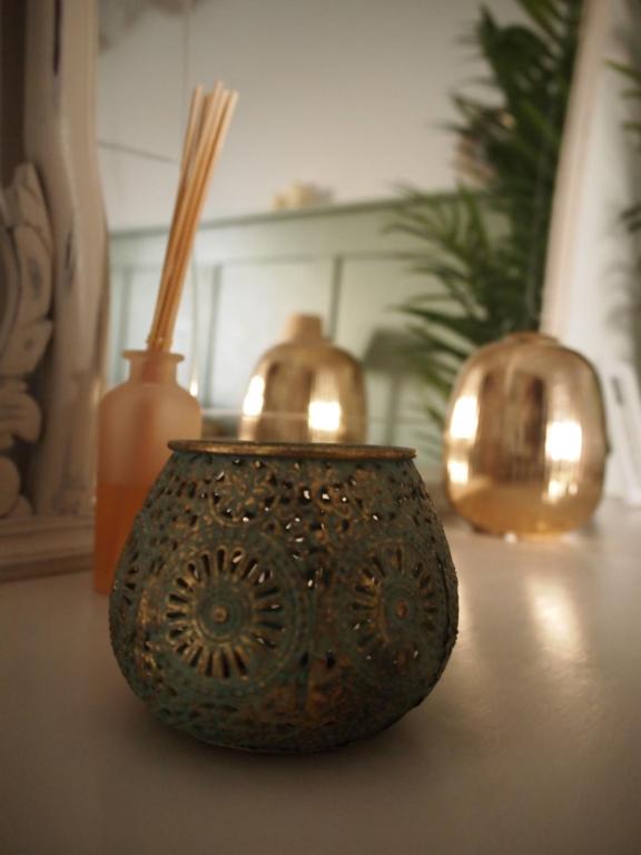 a vase sitting on top of a table with candles at El Sol del Membrillo in Corera