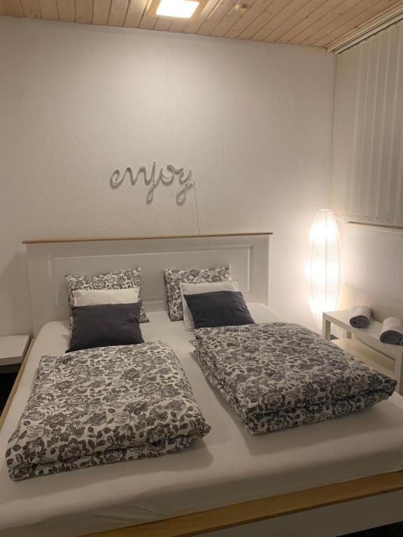 a bedroom with two beds and a sign on the wall at Guest room David 11 in St. Gallen