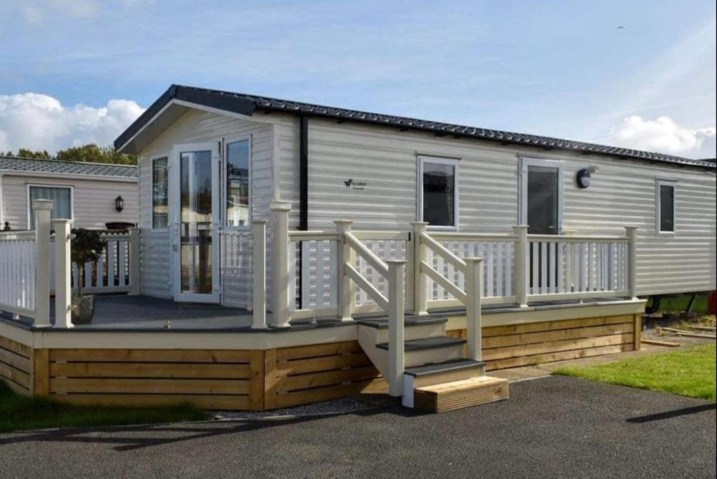 a mobile home with a porch and a deck at Brand New 2 Bedroom Lodge Perfect for Families in Morecambe