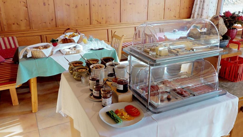 a table with food and drinks on a table at Das kleine Familienhotel Koch in Eisentratten