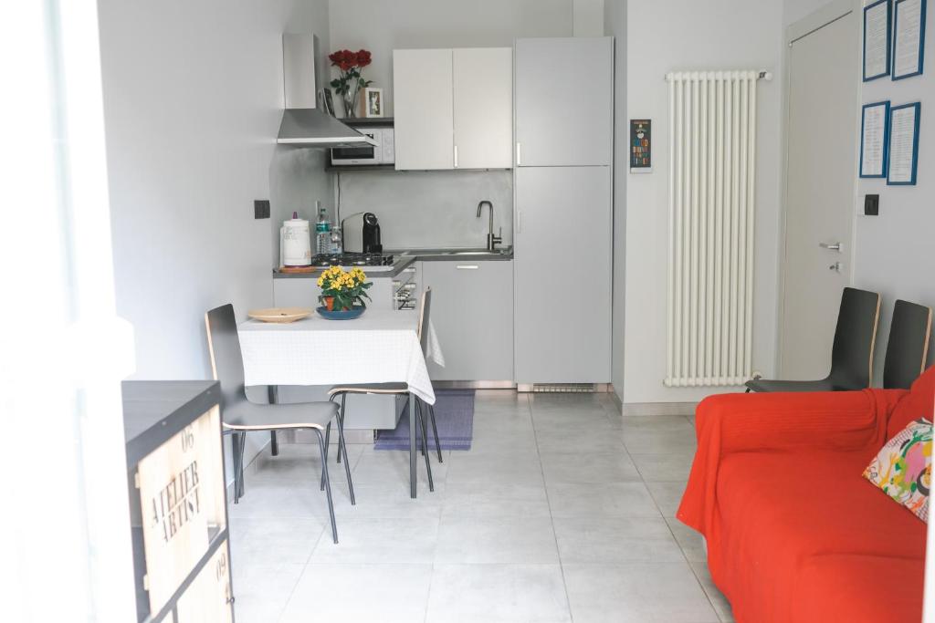 a kitchen and living room with a table and chairs at Auri's House in Turin