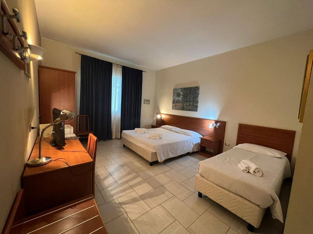 Postel nebo postele na pokoji v ubytování Hotel Adriatico