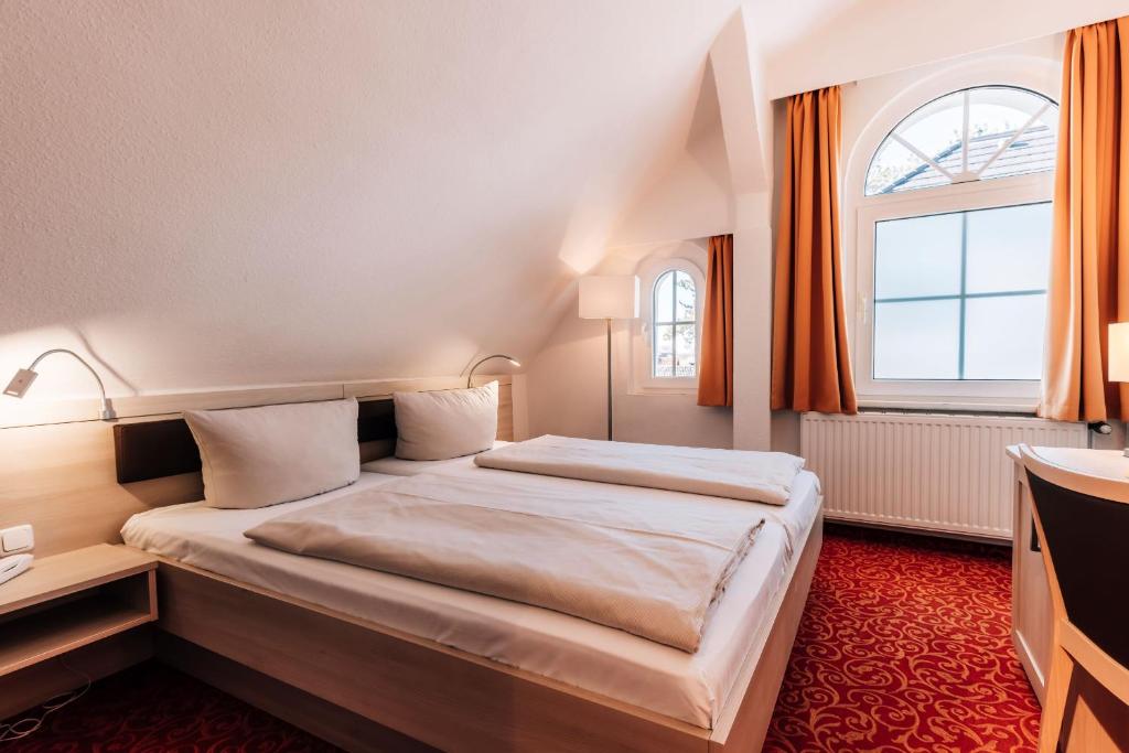 Postel nebo postele na pokoji v ubytování Hotel Gorch Fock