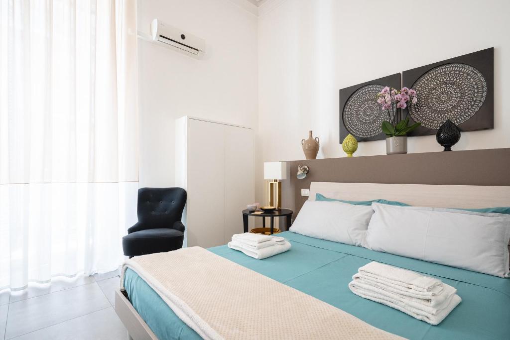 Łóżko lub łóżka w pokoju w obiekcie Fourooms - Bari Sparano