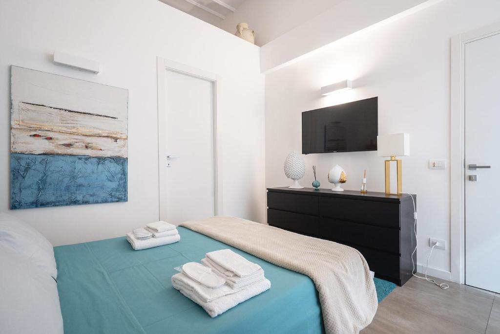 Łóżko lub łóżka w pokoju w obiekcie Fourooms - Bari Sparano
