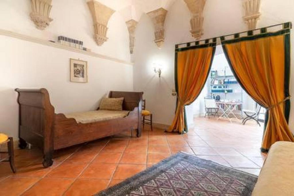 a living room with a couch and orange curtains at Dimora Santangelo in Lecce