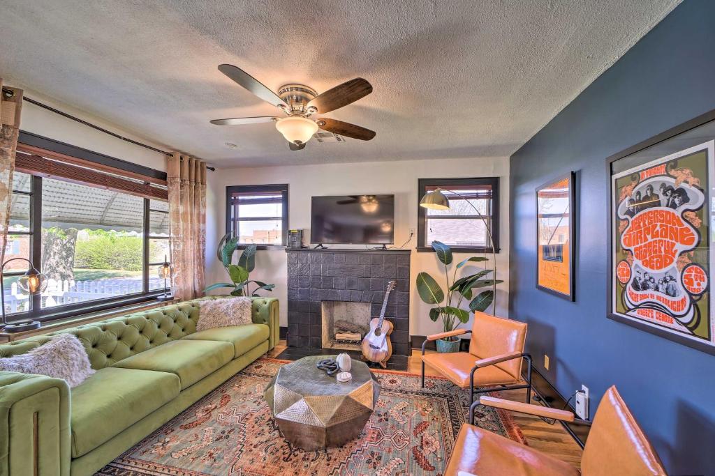 a living room with a green couch and a fireplace at Amazing Musical Abode in Expo Square Neighborhood! in Tulsa