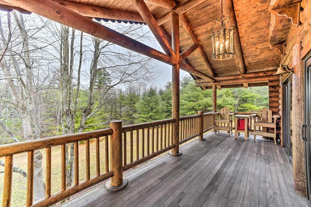 a large deck on a log cabin with a chandelier at Spacious Cabin with Decks Near Saratoga Springs in Middle Grove