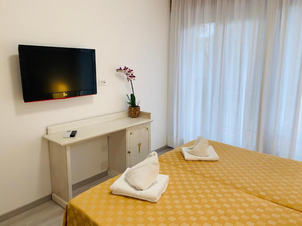 Postel nebo postele na pokoji v ubytování Hotel Adriaco