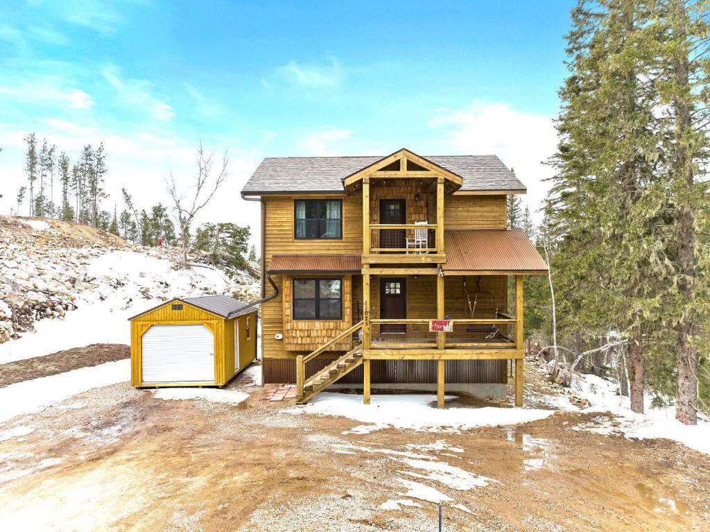 a wooden house with a deck in the snow at Whiskey Hills At Terry Peak in Lead