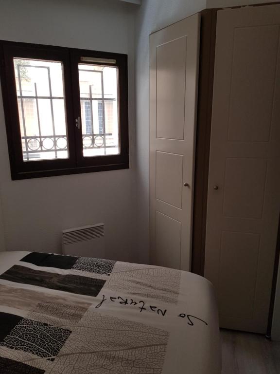 a bedroom with a bed and a window at Appartement en bord de mer in Cannes
