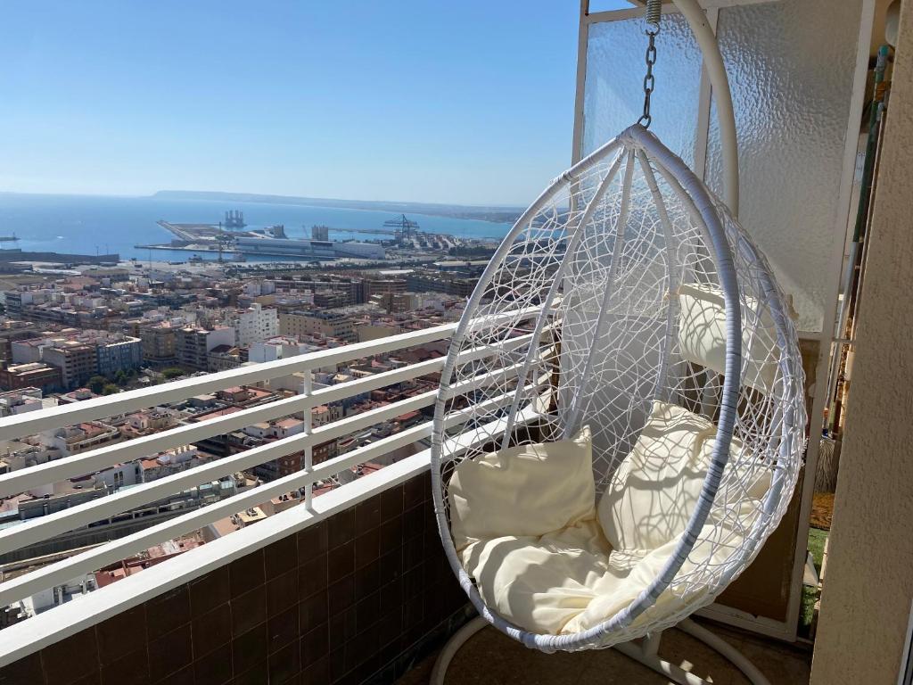 a hanging hammock on a balcony of a building at Apartamento 29th floor & sea view in Alicante