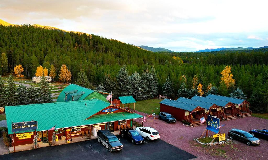 an aerial view of a resort with cars parked in a parking lot at Sky Eco - Glacier General Store and Cabins in Coram