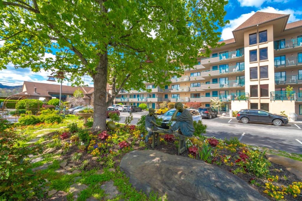 a statue of two people sitting on a bench in a park at Arbors at Island Landing Hotel & Suites in Pigeon Forge