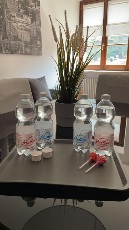 a table with four gallon bottles of water on it at Appartamento Palazzo dei Duchi in Avigliana