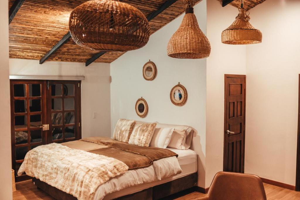 a bedroom with a bed and two baskets on the wall at leremita biohotel in Silvia