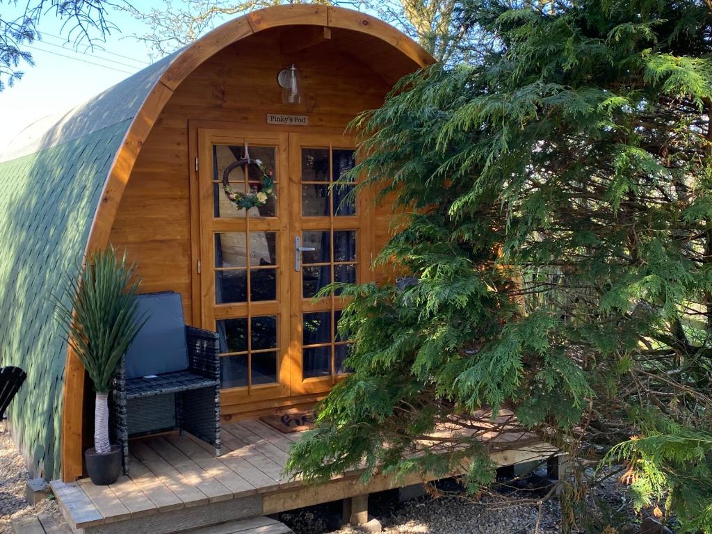 a hobbit house with a window and a desk in it at Pinkys Pod at Rock Lodge in Alnwick