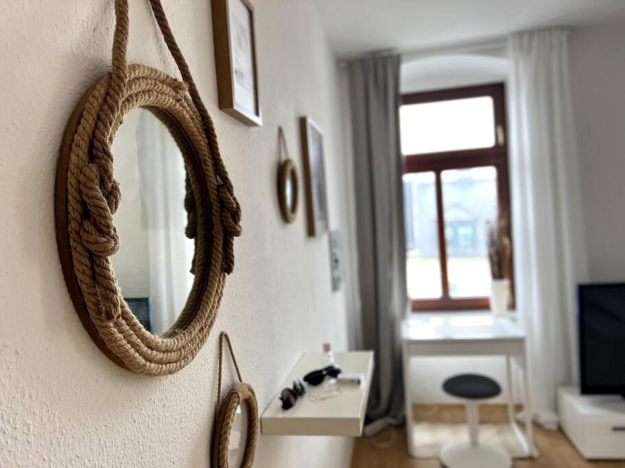 a mirror on a wall in a living room at ~In der Natur und dennoch zentral~ in Annaberg-Buchholz