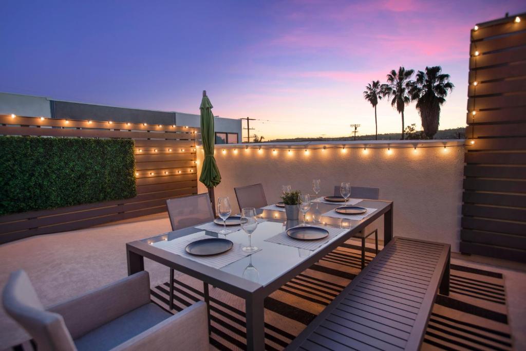 a patio with a table and chairs and lights at LA #FleetWeek Home with Private Rooftop near #DTLA in San Pedro