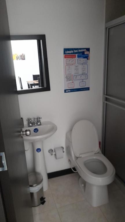 a bathroom with a toilet and a sink at Apartamentos a 3 minutos del Parque del Café in Armenia