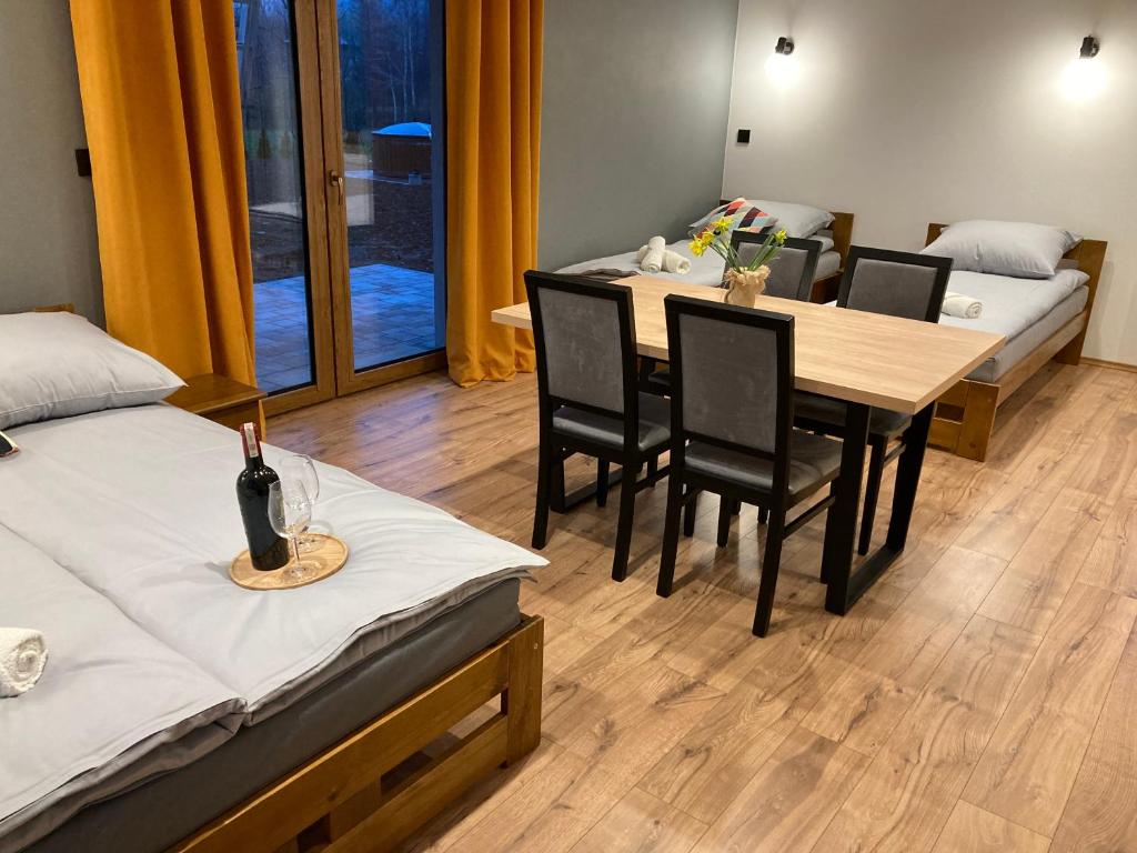 pokój z dwoma łóżkami, stołem i krzesłami w obiekcie Rezydencja pod Cergową Wellness & SPA w mieście Dukla
