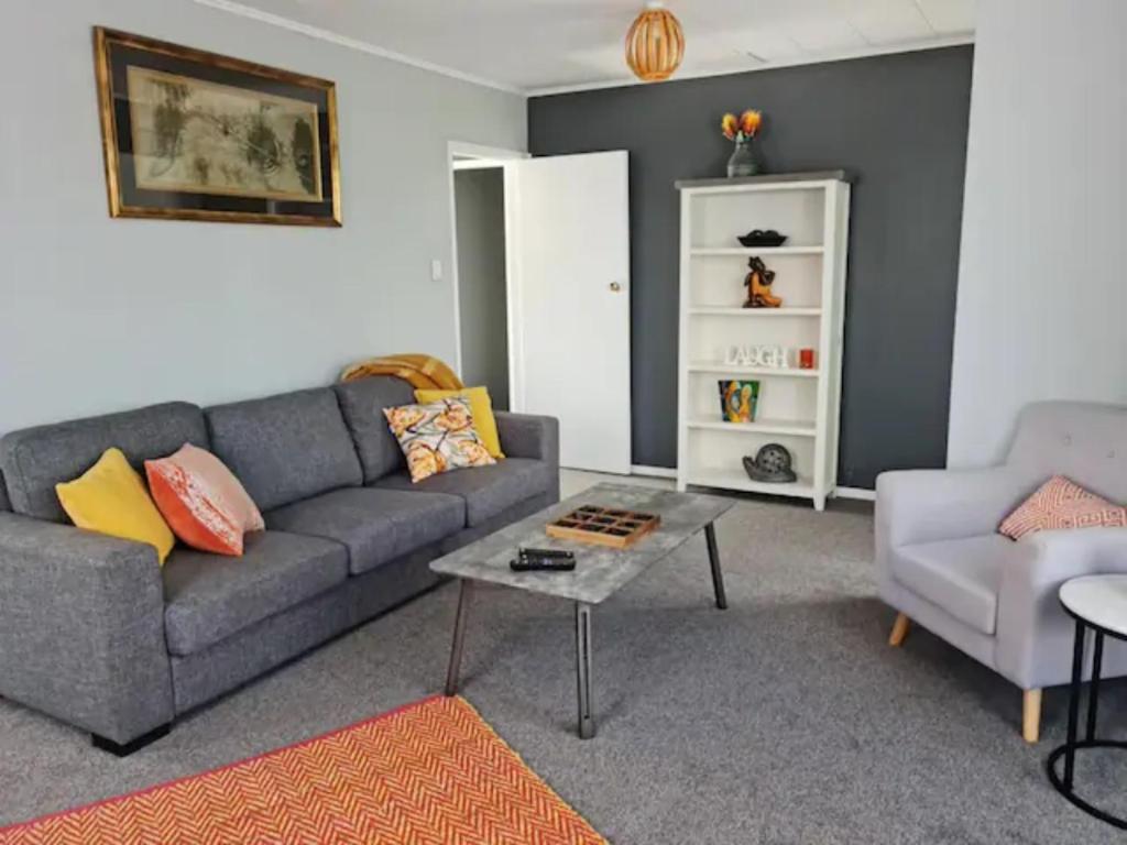 sala de estar con sofá y mesa en Gondola Views on Mallard en Rotorua