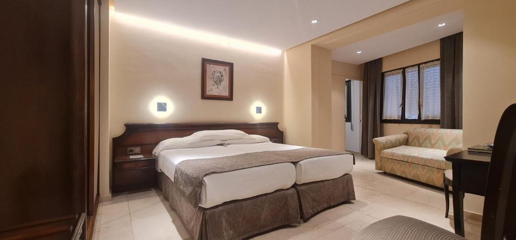 Postel nebo postele na pokoji v ubytování Gran Hotel Paraiso