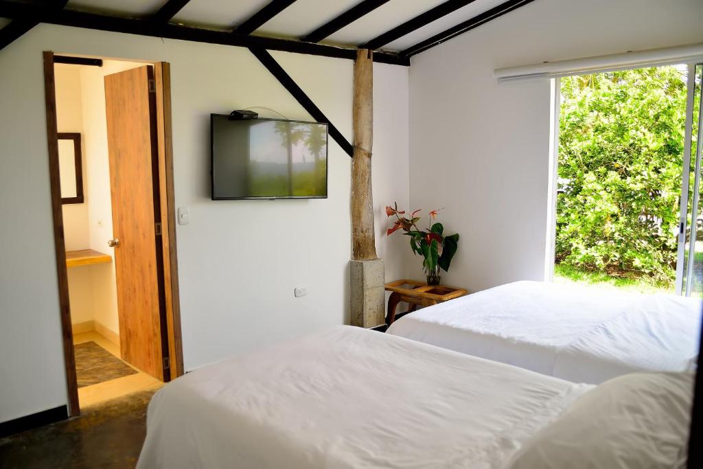 Cama o camas de una habitación en ORIGEN FINCA HOTEL