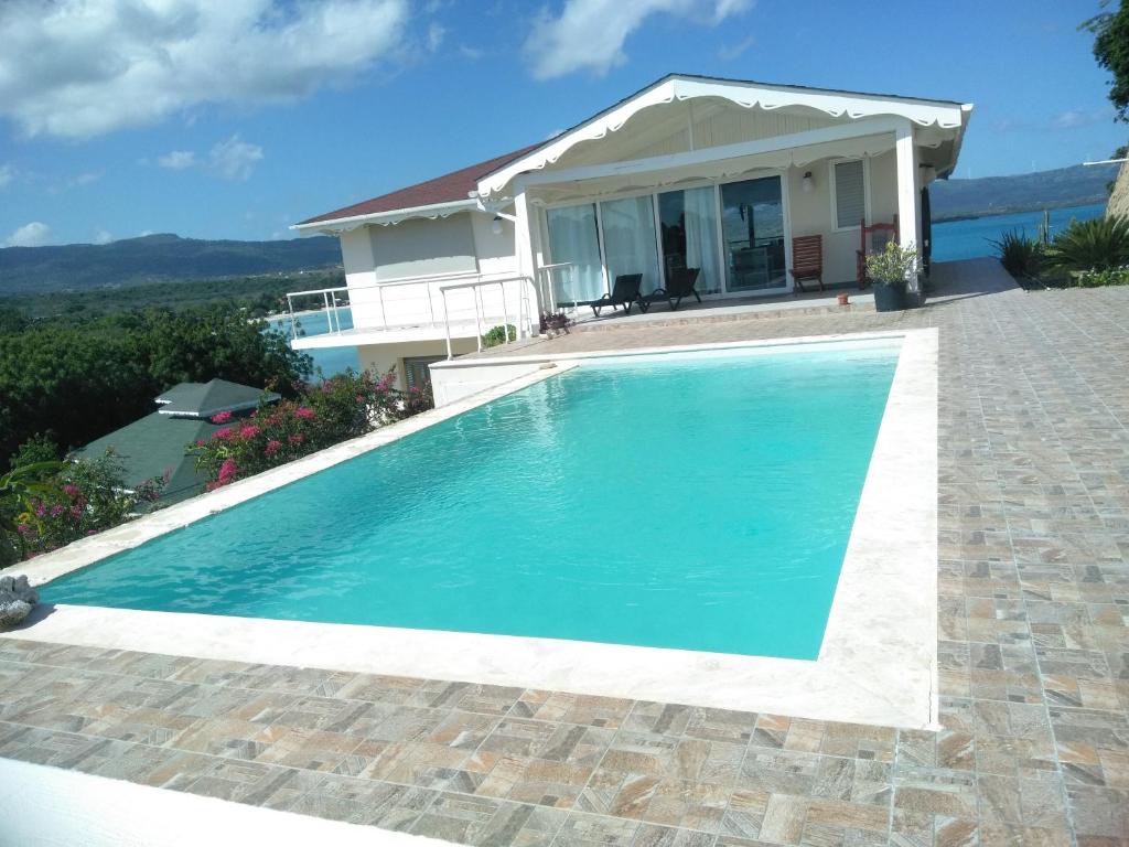 a swimming pool in front of a house at Villa Daniela in Punta Rucia