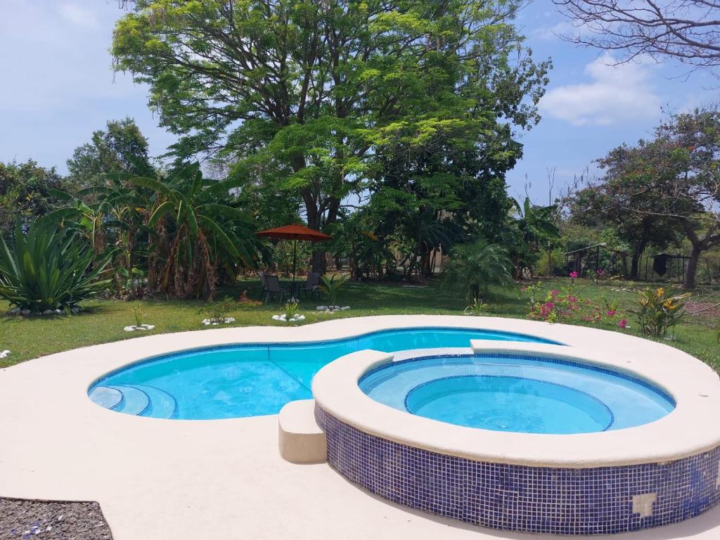 a large swimming pool with a coping around it at BEAUTIFUL HOUSE IN LAS UVAS SAN CARLOS, PANAMA WITH FRUIT TREES -SWIMMING POOL in Las Uvas