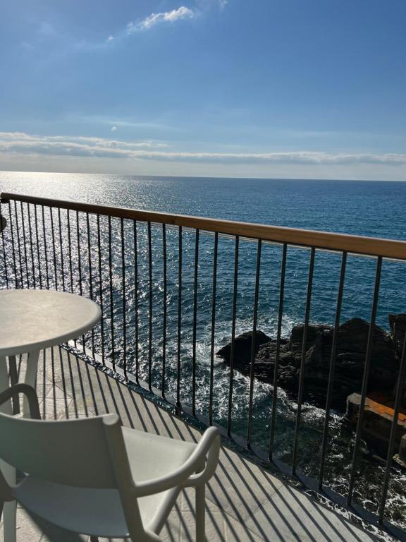 a balcony with a table and a view of the ocean at La Ripa Camere Vernazza in Vernazza