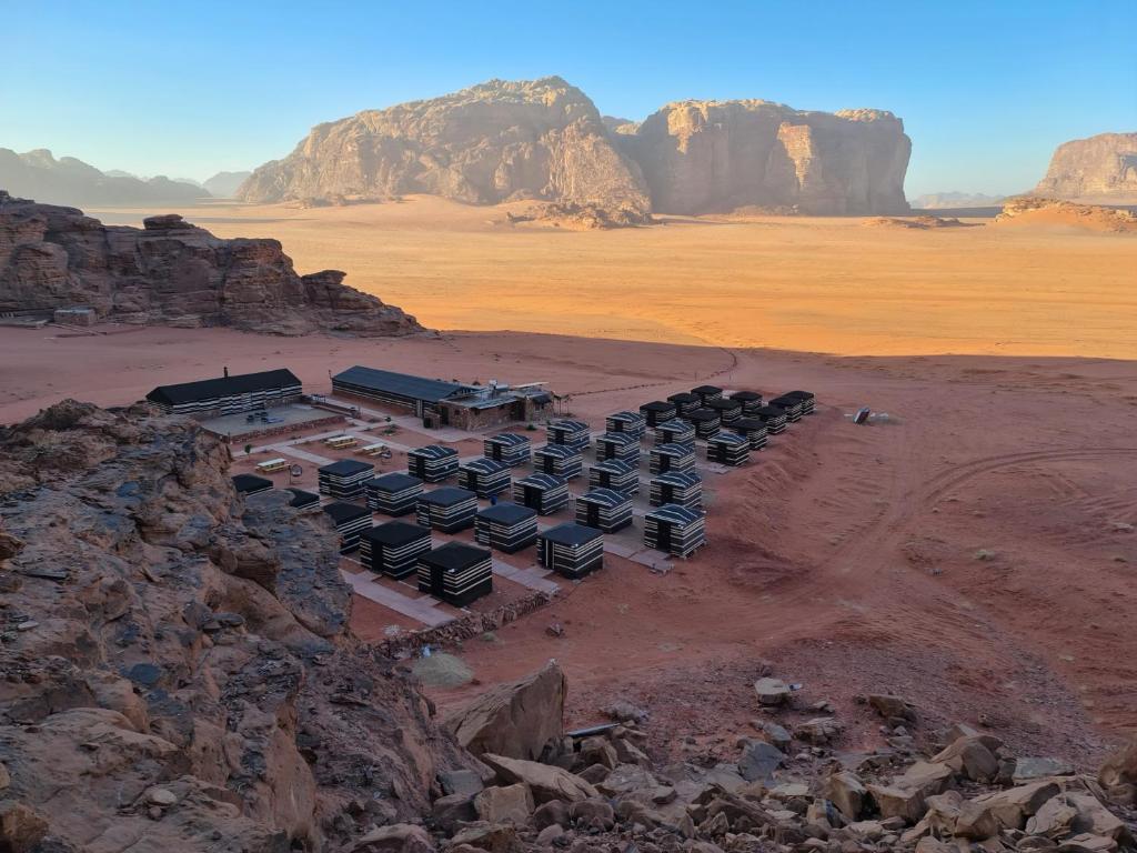 a group of buses parked in the desert at Wadi Rum Caravan Camp in Wadi Rum