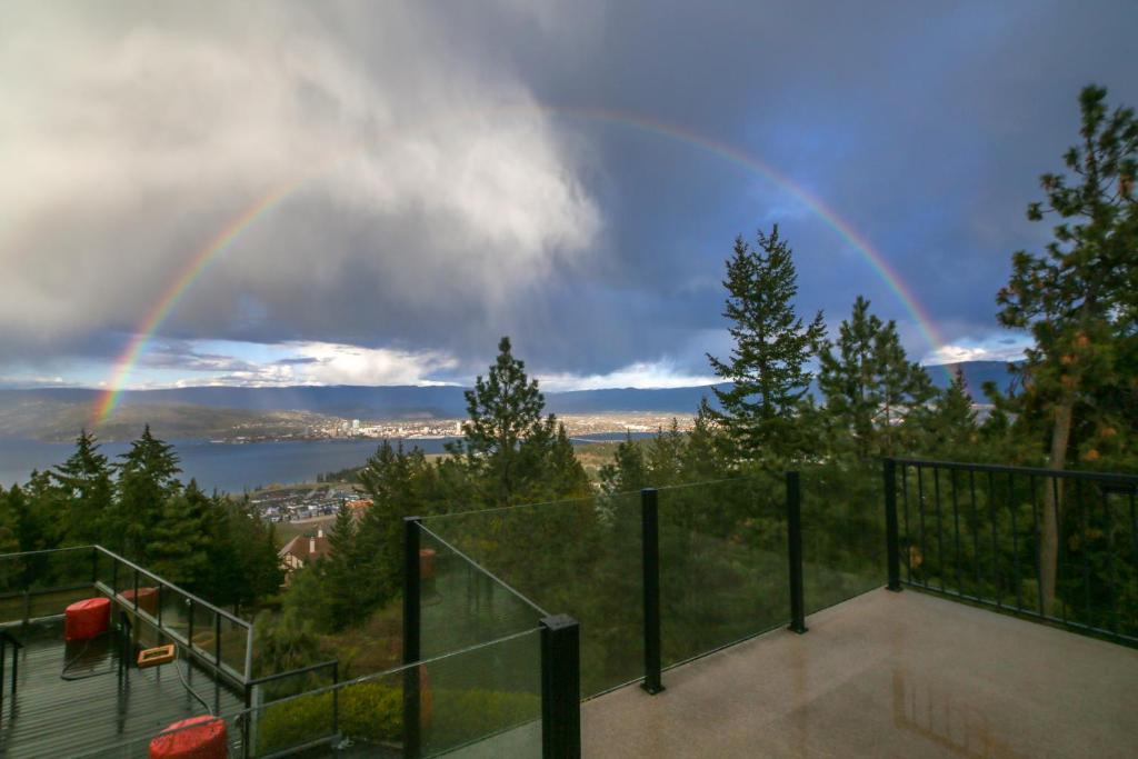 a rainbow in the sky over a city at Honeymoon Suite in West Kelowna