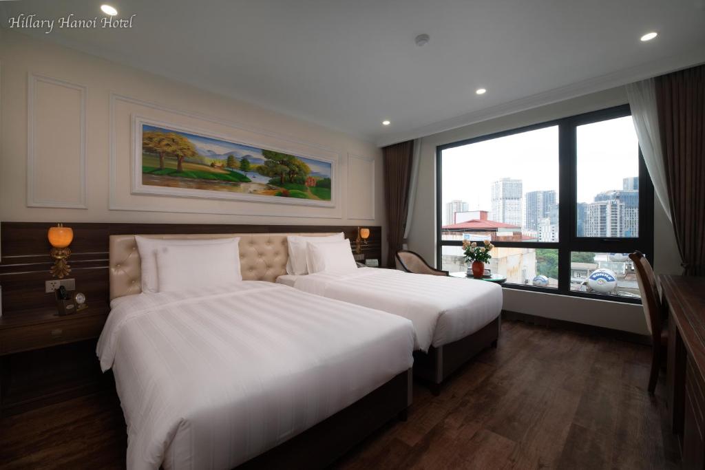 Postel nebo postele na pokoji v ubytování Hillary Hanoi Hotel