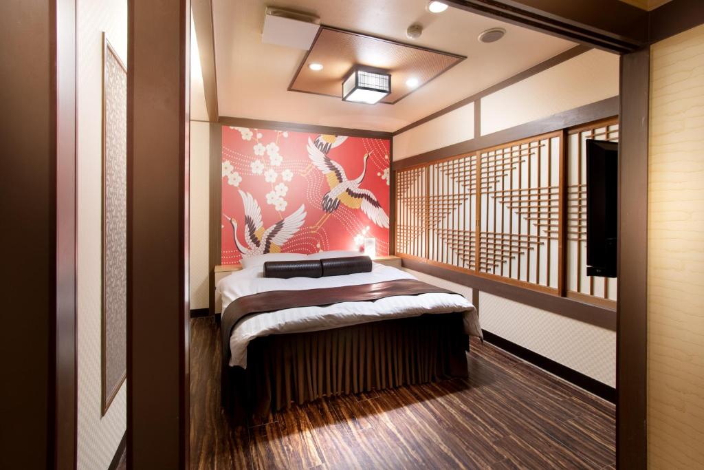 Postel nebo postele na pokoji v ubytování Hotel Benkyo Beya Amagasaki