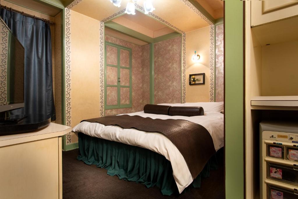 Postel nebo postele na pokoji v ubytování Hotel Benkyo Beya Amagasaki