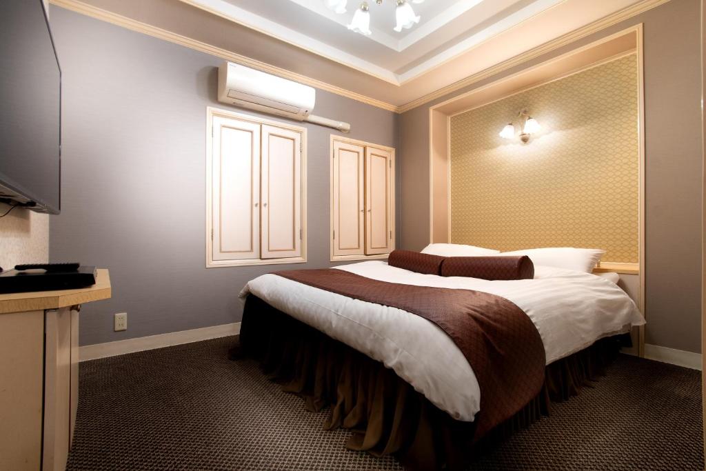 Postel nebo postele na pokoji v ubytování Hotel Benkyo Beya Amagasaki