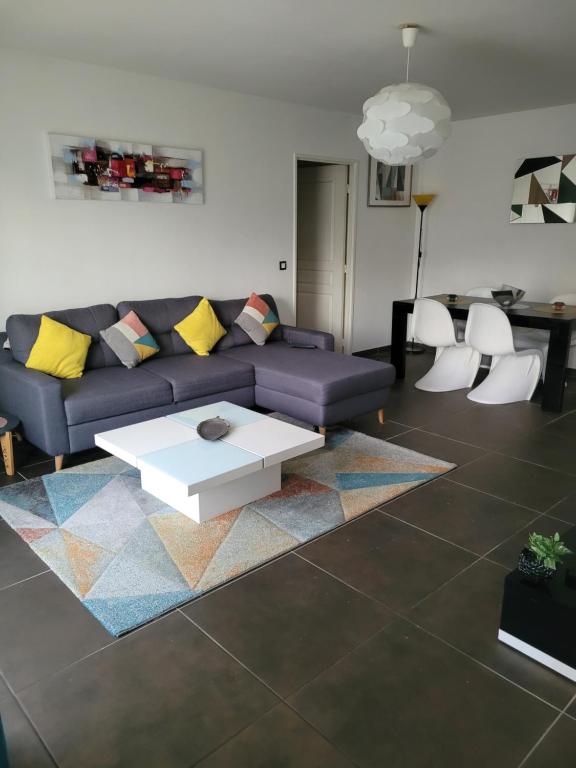 a living room with a couch and a table and chairs at Appartement privée Lyon 3 in Lyon