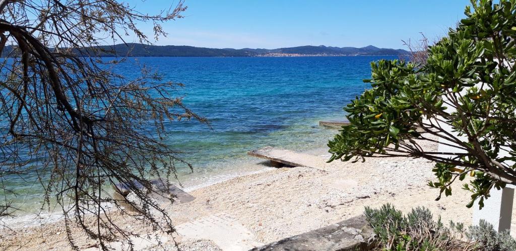 a view of a beach with the blue water at Sea house in Bibinje