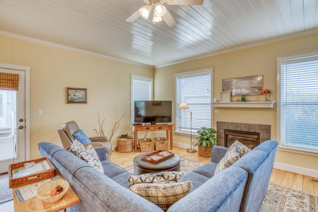 a living room with blue couches and a fireplace at Ocean Gem in Lincoln City