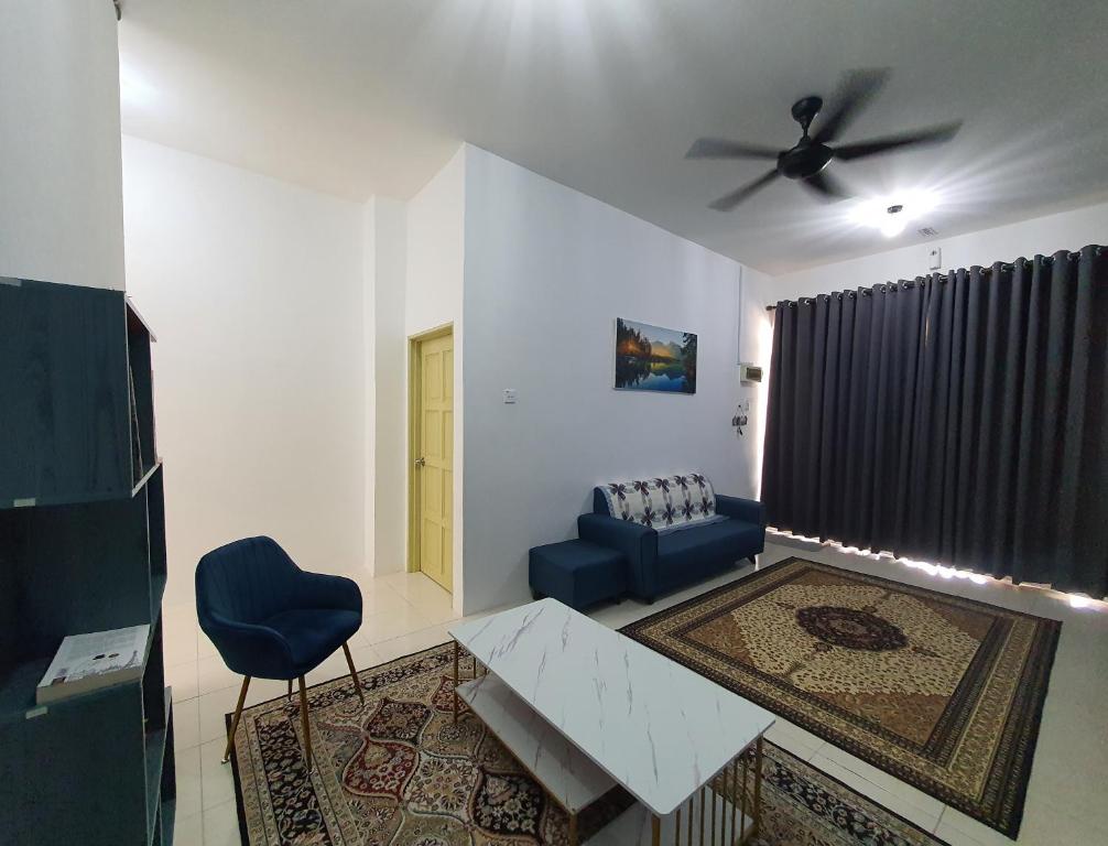 a living room with a couch and a ceiling fan at Licuala Homestay Bukit Keluang in Kampung Raja