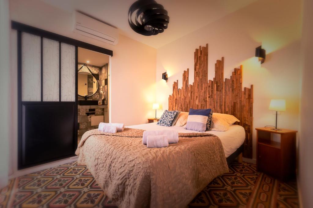 a bedroom with a large bed with towels on it at A Fontana in Zonza