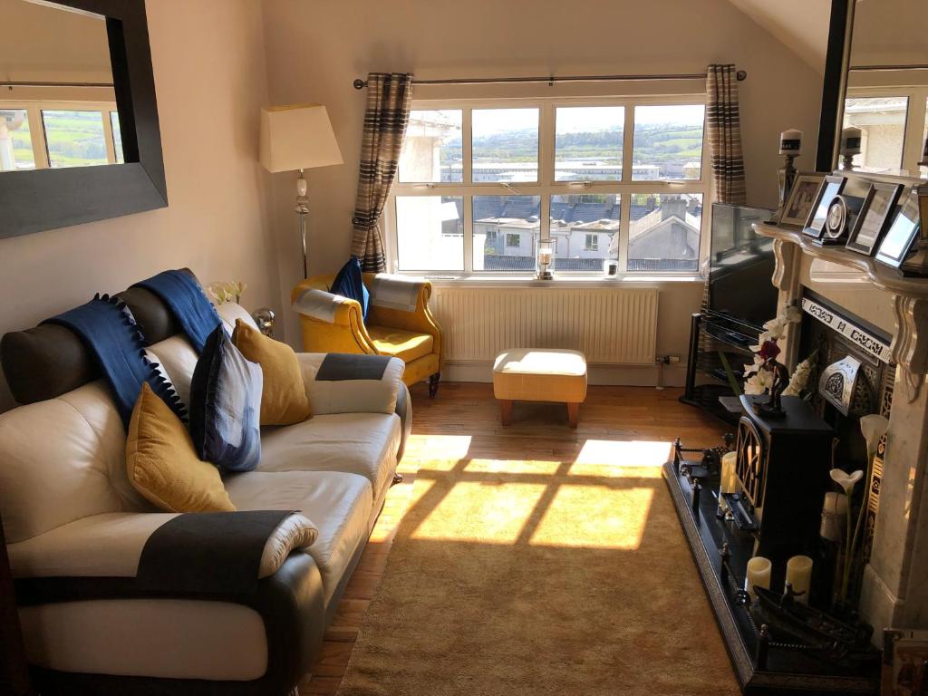 a living room with a couch and a window at 15 Main Street (Classic Casuals) in Letterkenny