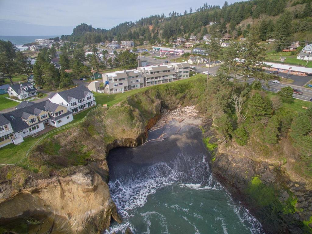 an aerial view of a cliff with houses and the ocean at Salt Therapy in Depoe Bay