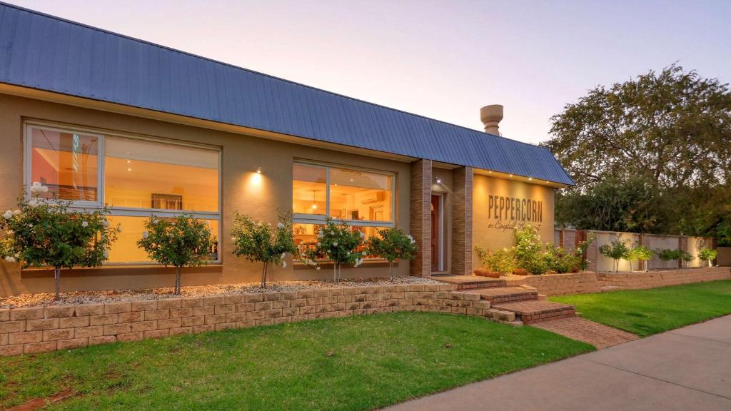 a house with a blue roof and a yard at Quality Inn Swan Hill in Swan Hill