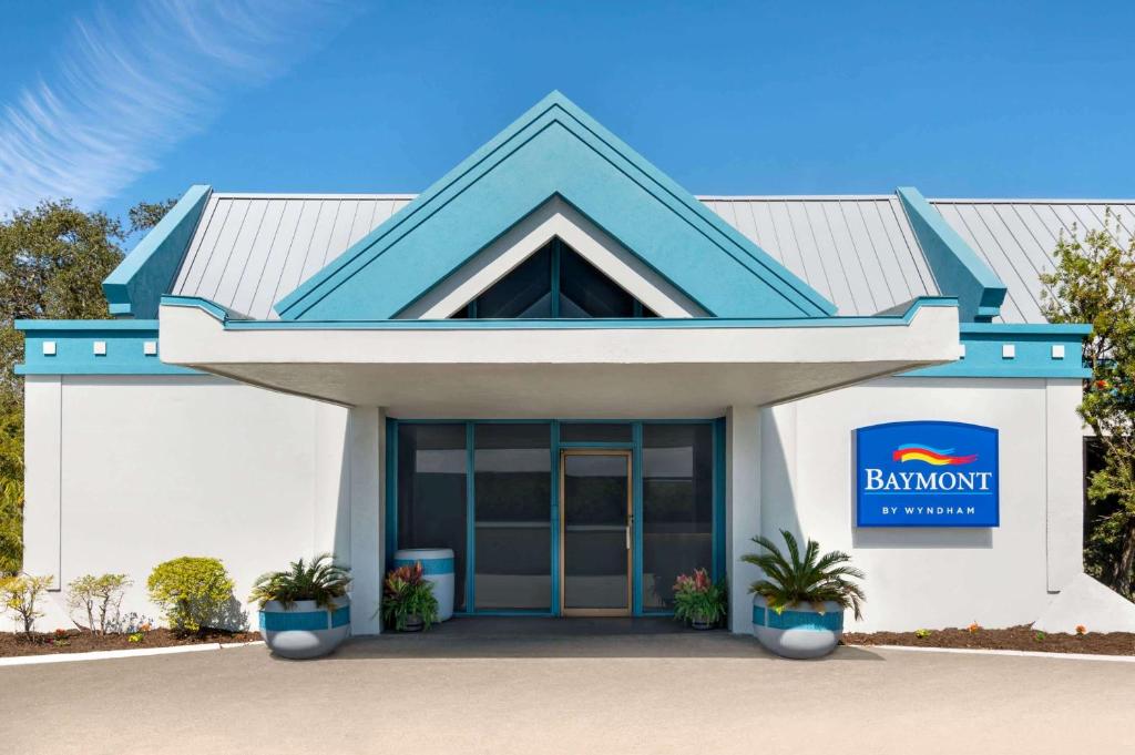 a bahamut building with a sign on it at Baymont by Wyndham Daytona Beach - Intl Speedway in Daytona Beach
