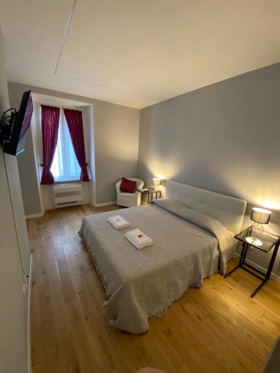 a bedroom with a large bed and a window at Cavour Home in Rome