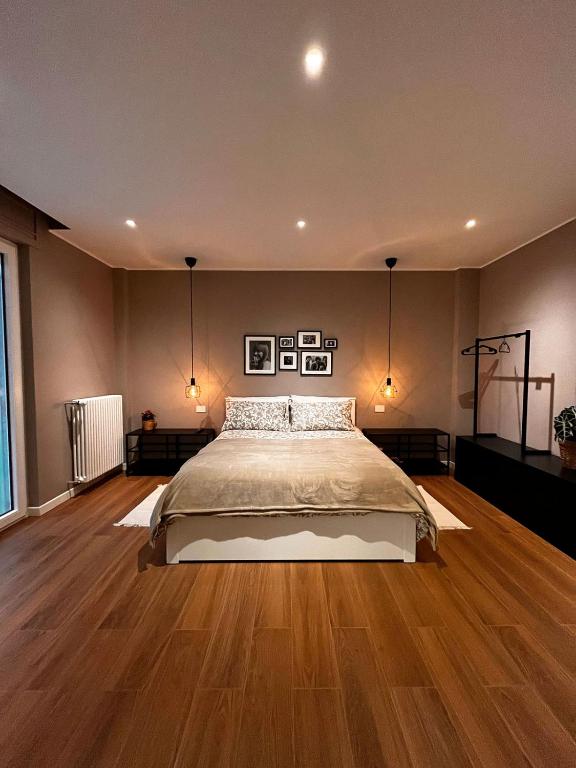 a bedroom with a bed and a wooden floor at DeGasperi Studio Apartment in Trani