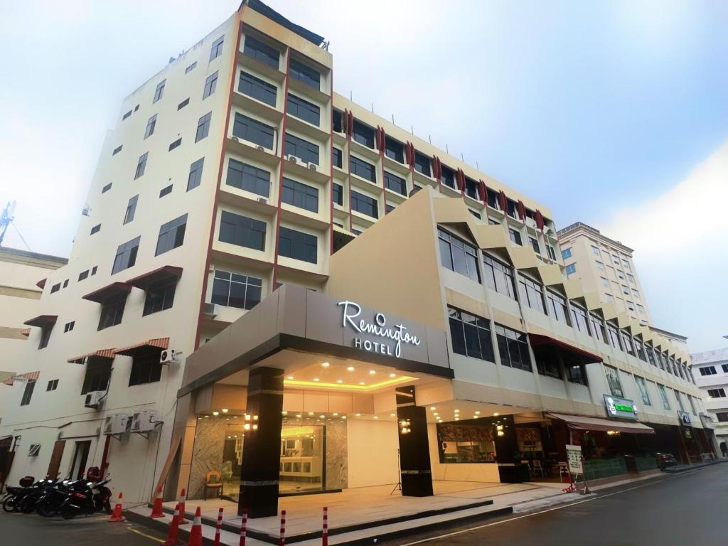 a tall building with a store on the street at Remington Hotel in Muar