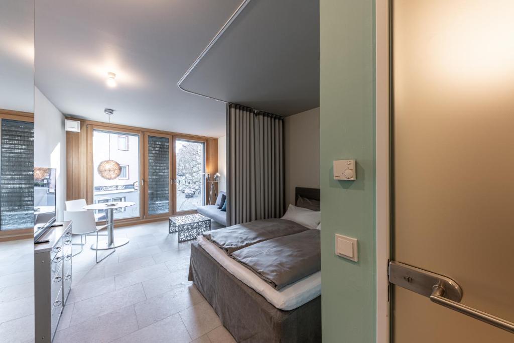 WEST Apartments في شورندورف: غرفة نوم بسرير ومكتب في غرفة